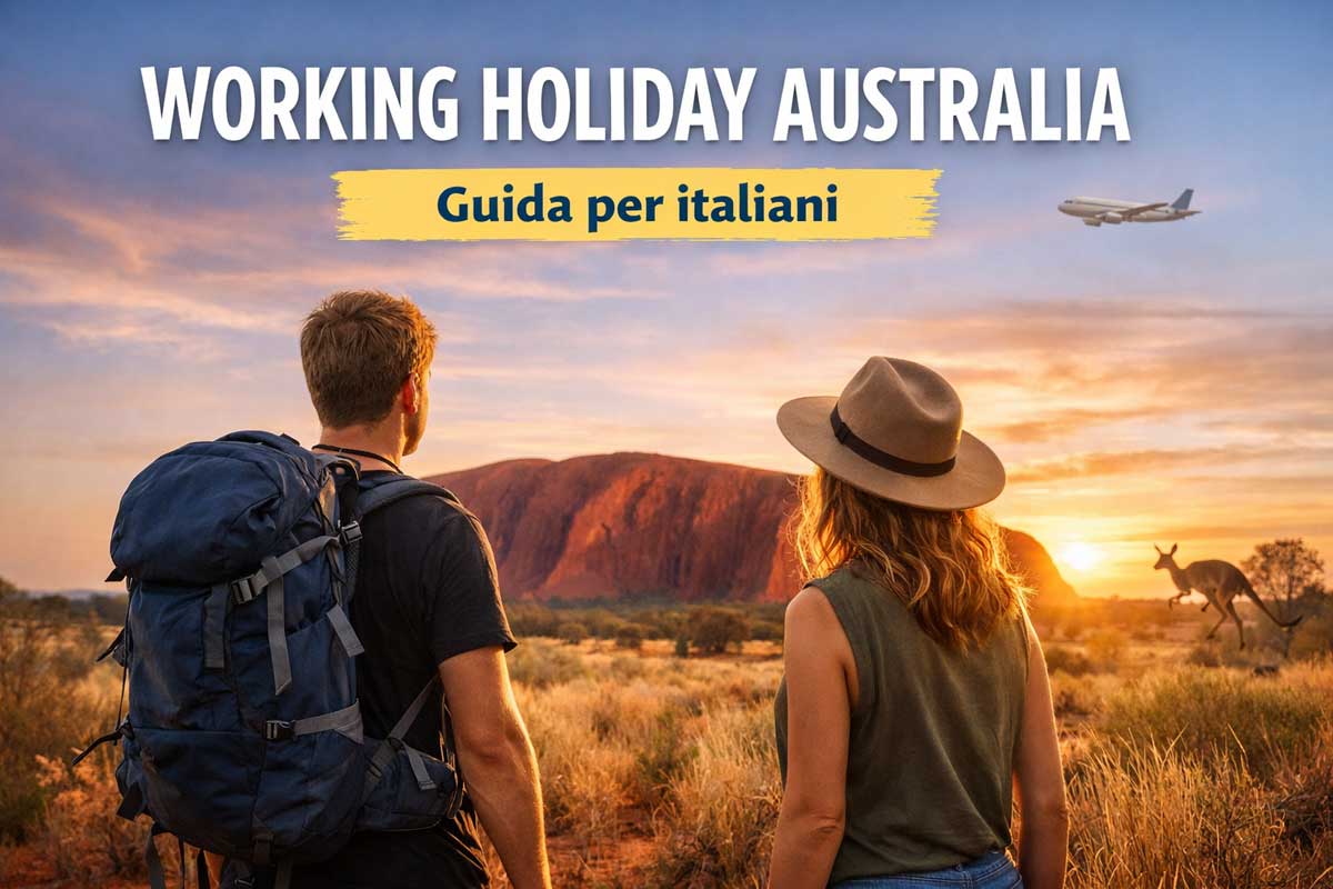 Due giovani viaggiatori davanti a Uluru al tramonto durante un Working Holiday in Australia